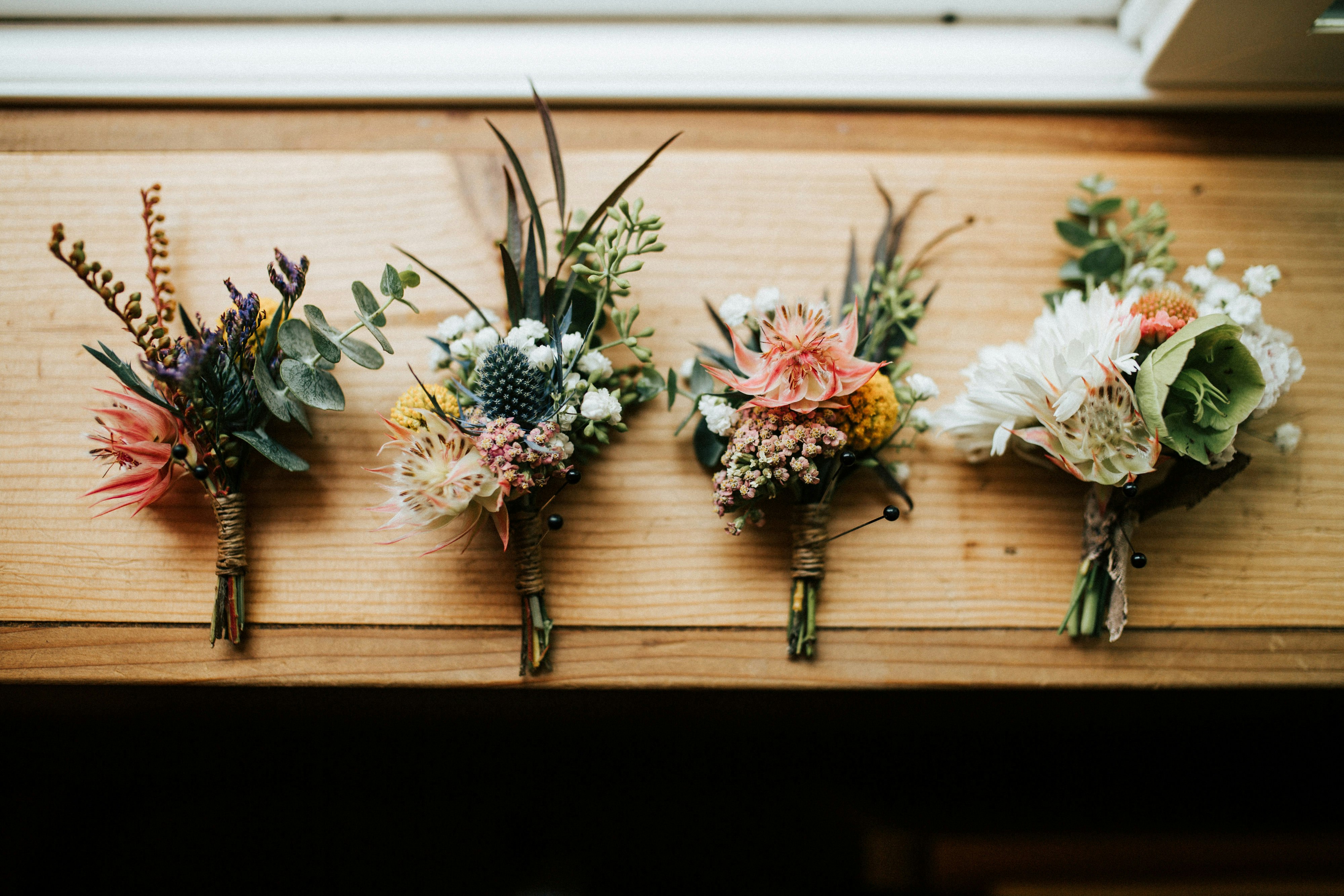 three flower bouquets on table